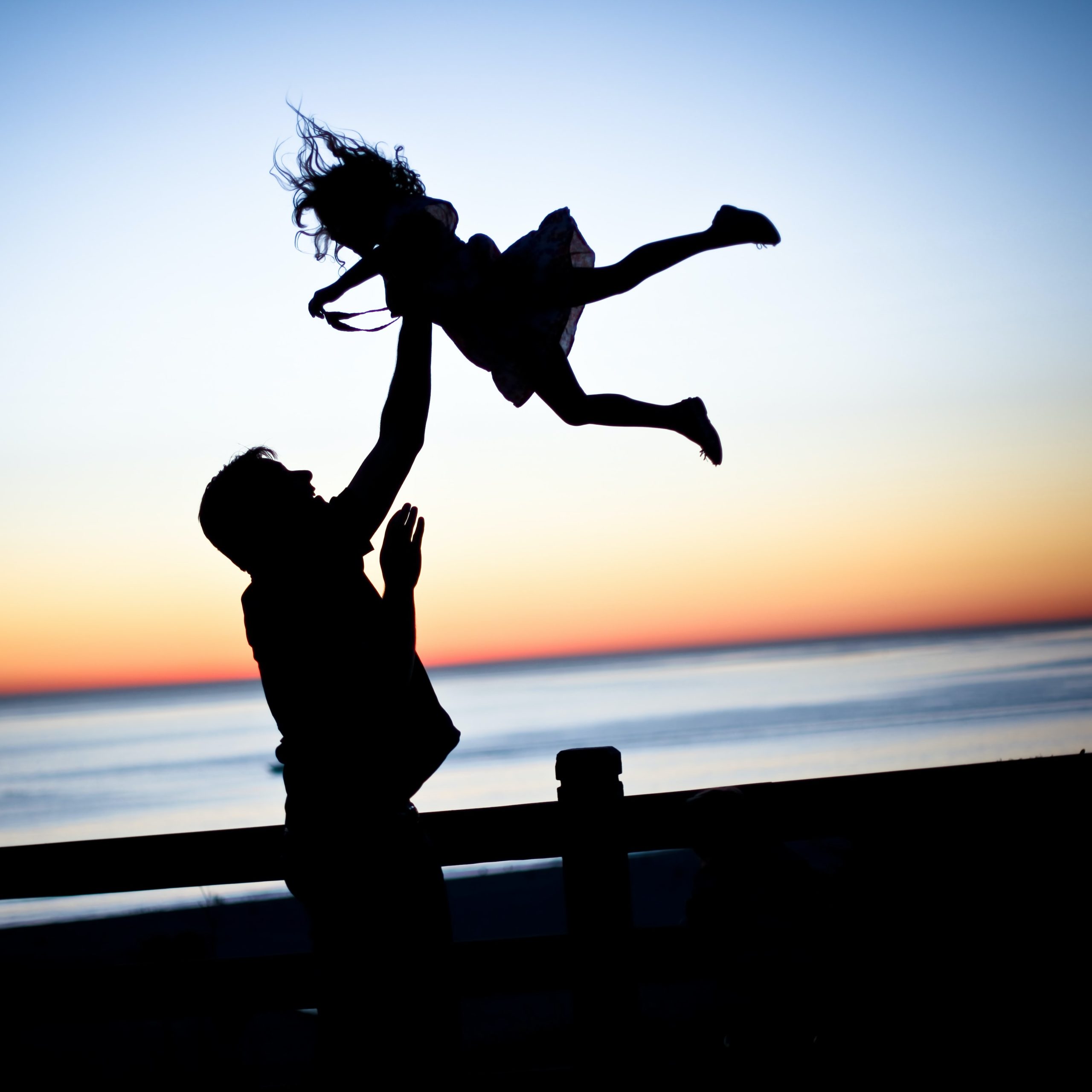 dad throwing daughter in air